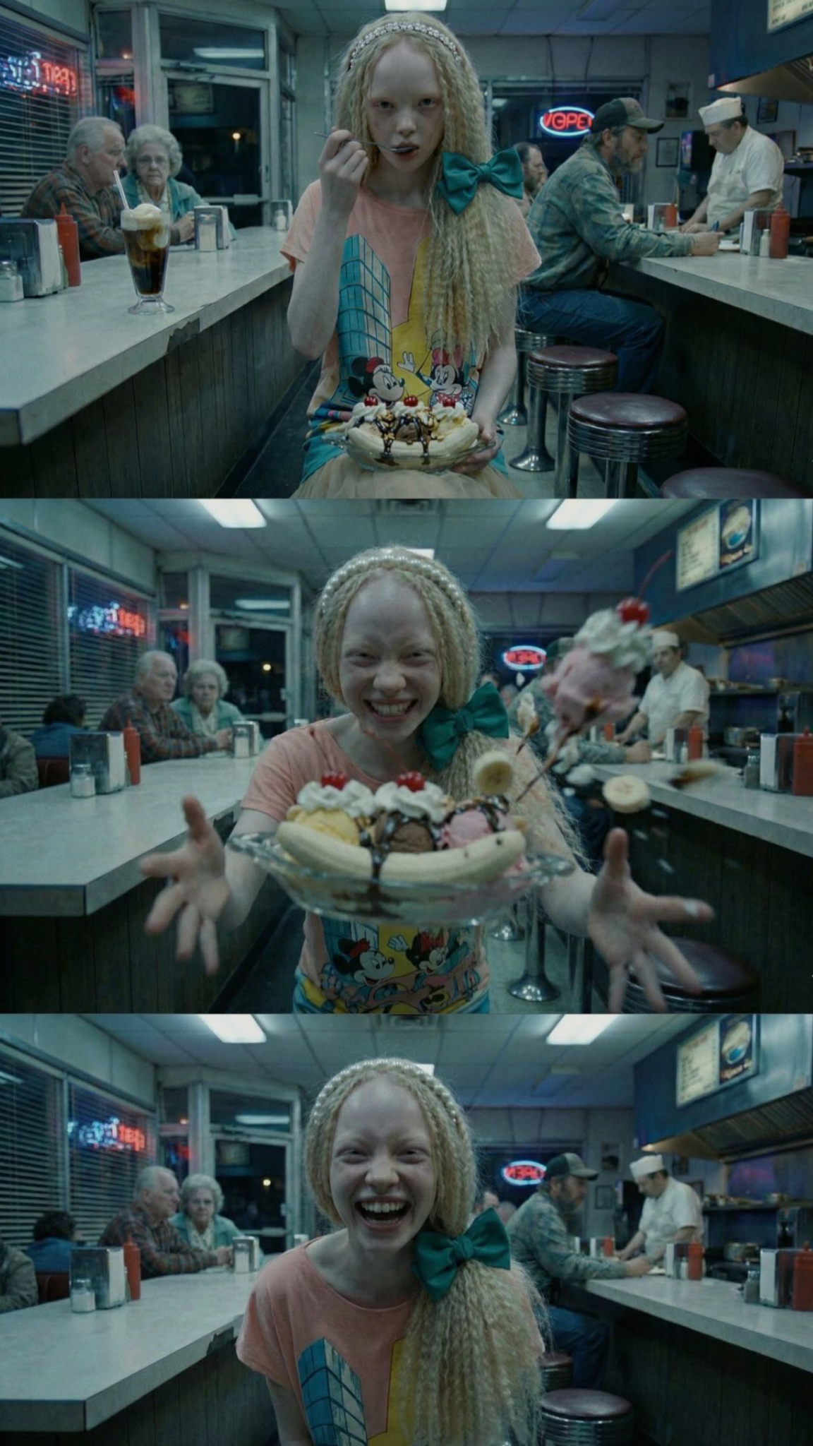 Film still in a neon-lit diner.